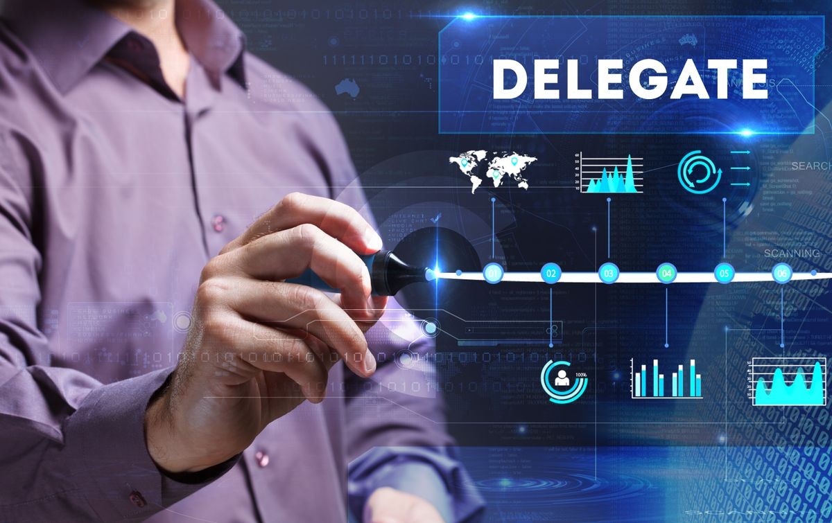 Technology, Internet, business and marketing. Young business person sees the word: delegate