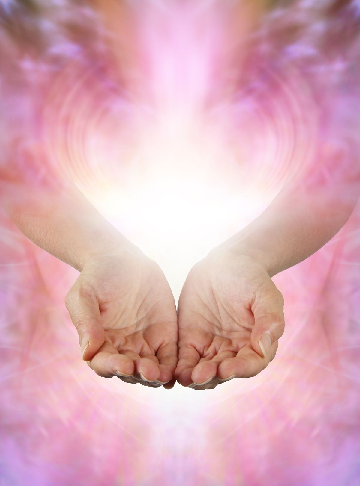 Sharing Abundance Healing Energy with You - Female open cupped hands with vibrant white light and gentle pink energy field offering beautiful energy with copy space for your message
    